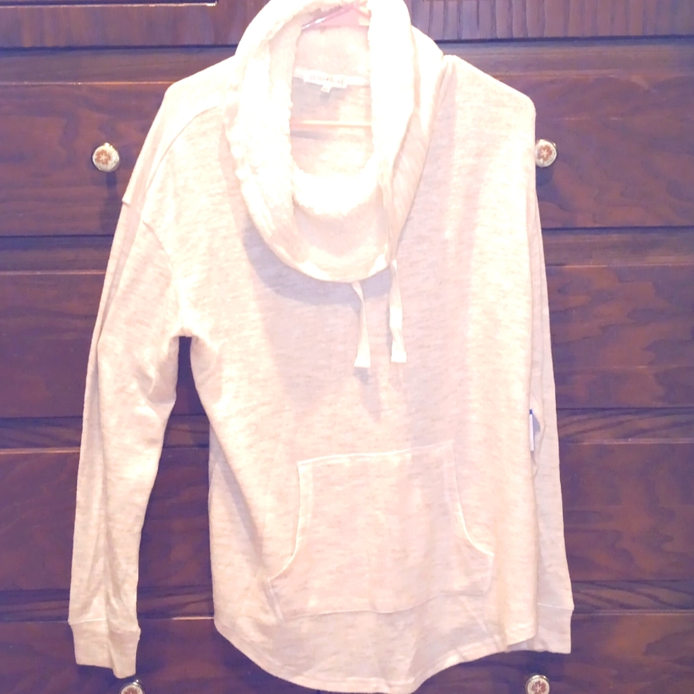 A tan funnel blouse